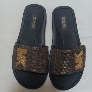 Black, gold slides/slippers.